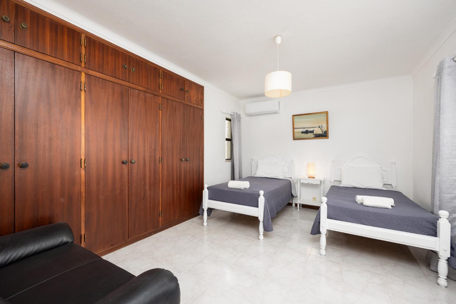 Twin bedroom with en suite bathroom and A/C