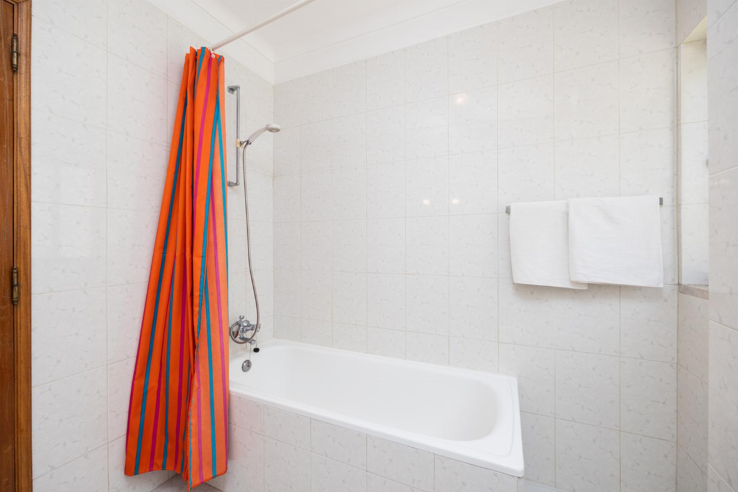 En suite bathroom with bath and shower