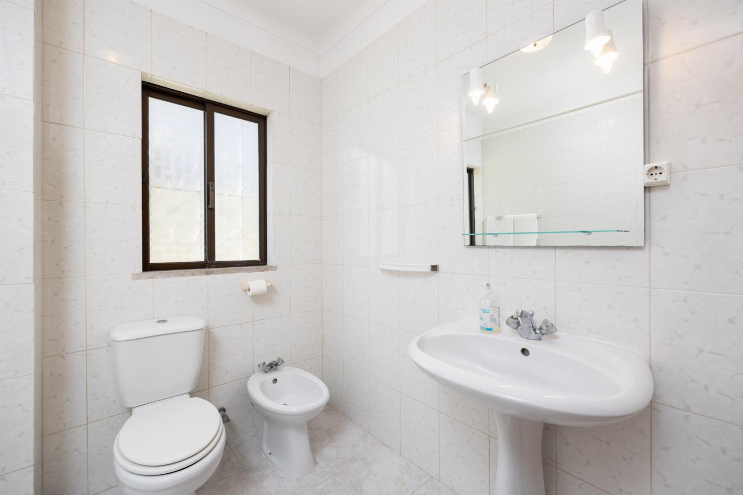 En suite bathroom with bath and shower
