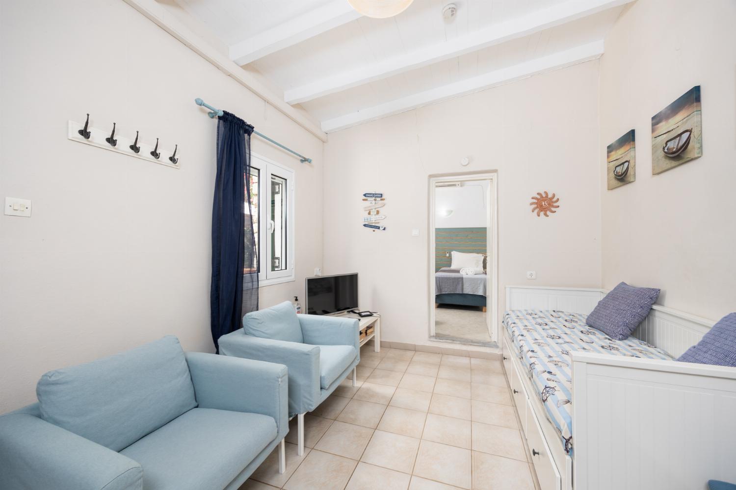 Open-plan living room with seating, dining area, kitchen, WiFi internet, and satellite TV