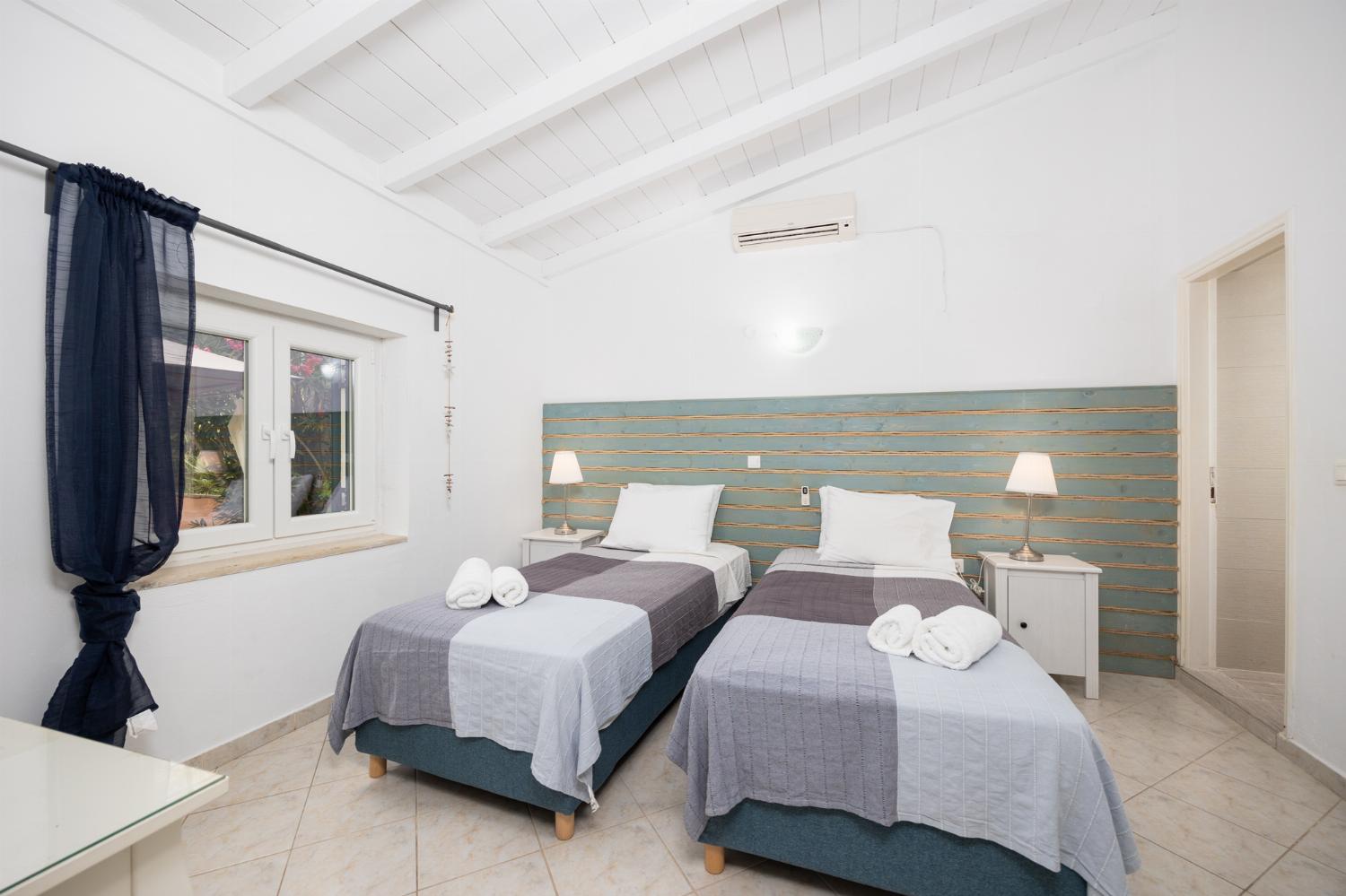 Twin bedroom with en suite bathroom and A/C