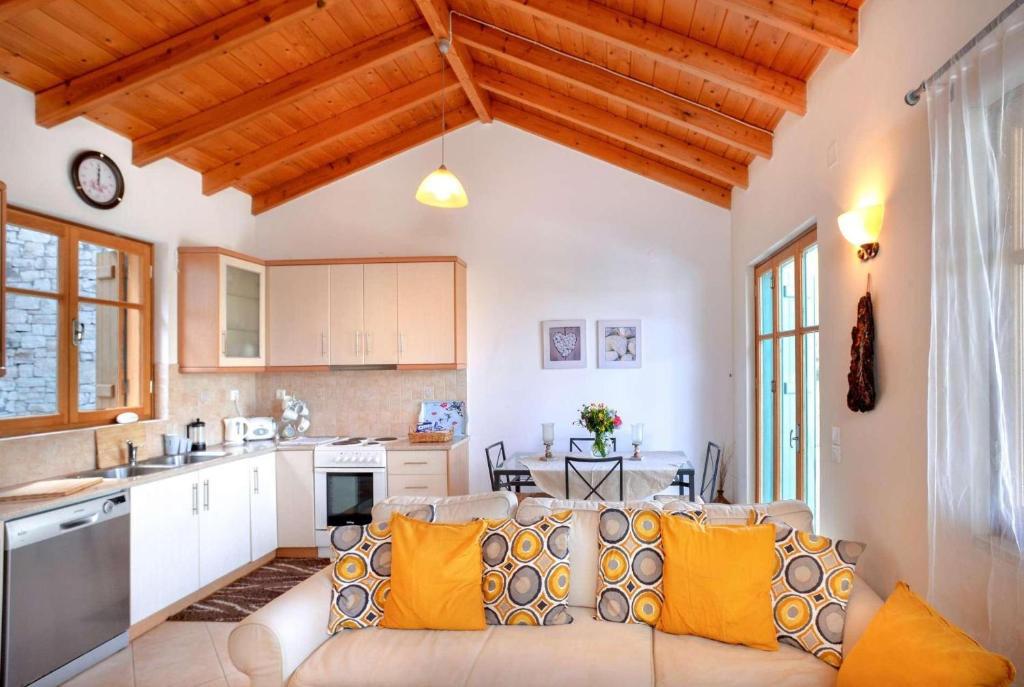 Open-plan living room with sofas, dining area, kitchen, A/C, WiFi internet, and satellite TV