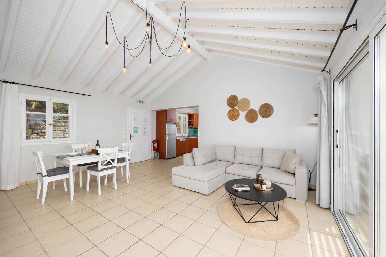 Open-plan living room with sofa, dining area, kitchen, A/C, WiFi internet, satellite TV, and sea views