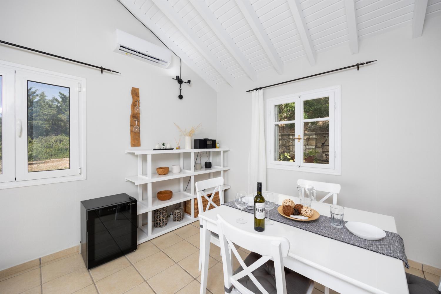 Open-plan living room with sofa, dining area, kitchen, A/C, WiFi internet, satellite TV, and sea views