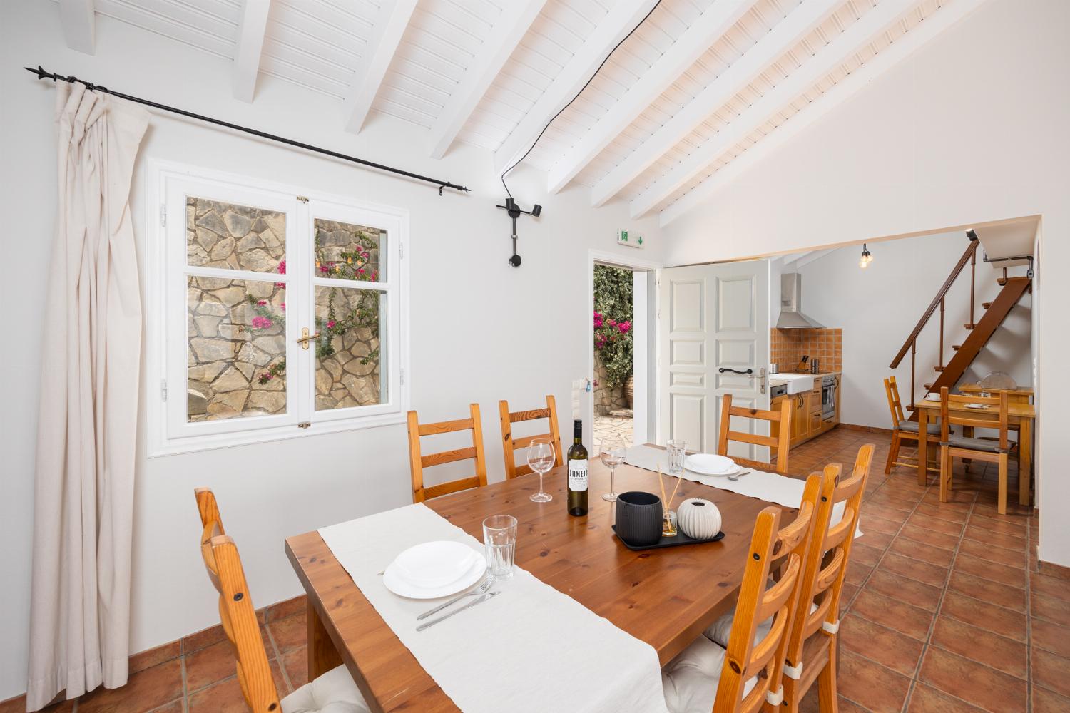 Open-plan living room with sofa, dining area, kitchen, ornamental fireplace, A/C, WiFi internet, satellite TV, and sea views