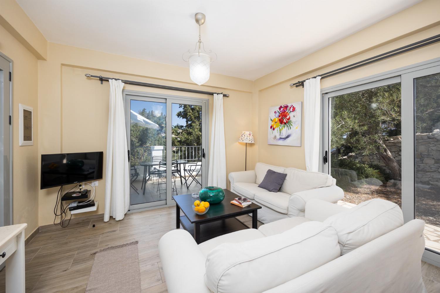 Open-plan living room with sofas, dining area, kitchen, WiFi internet, and satellite TV