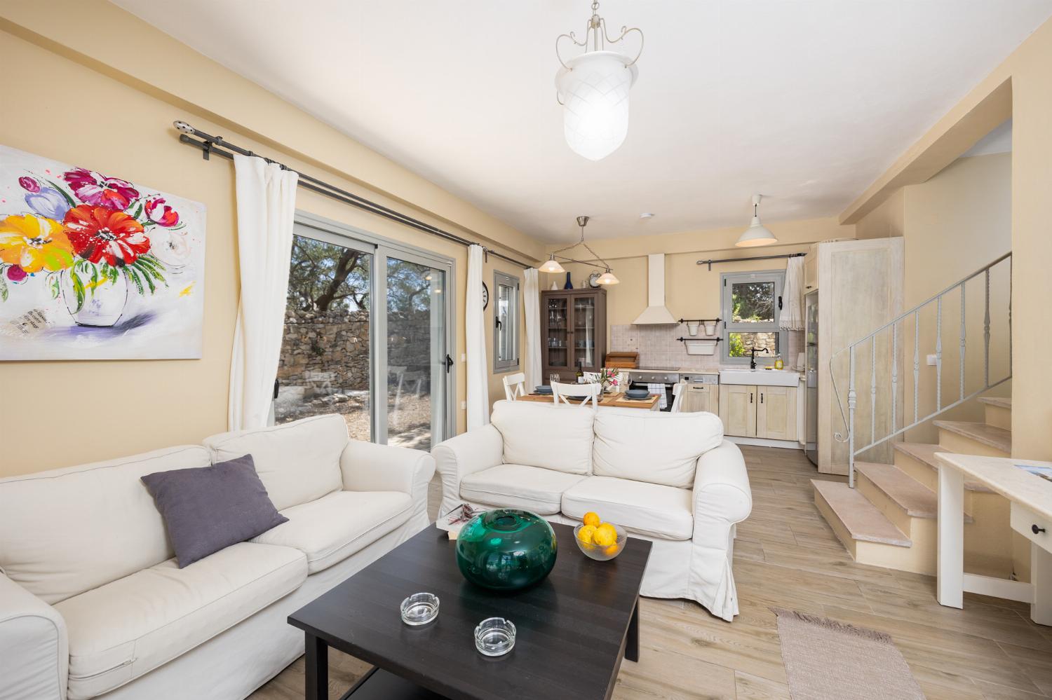 Open-plan living room with sofas, dining area, kitchen, WiFi internet, and satellite TV