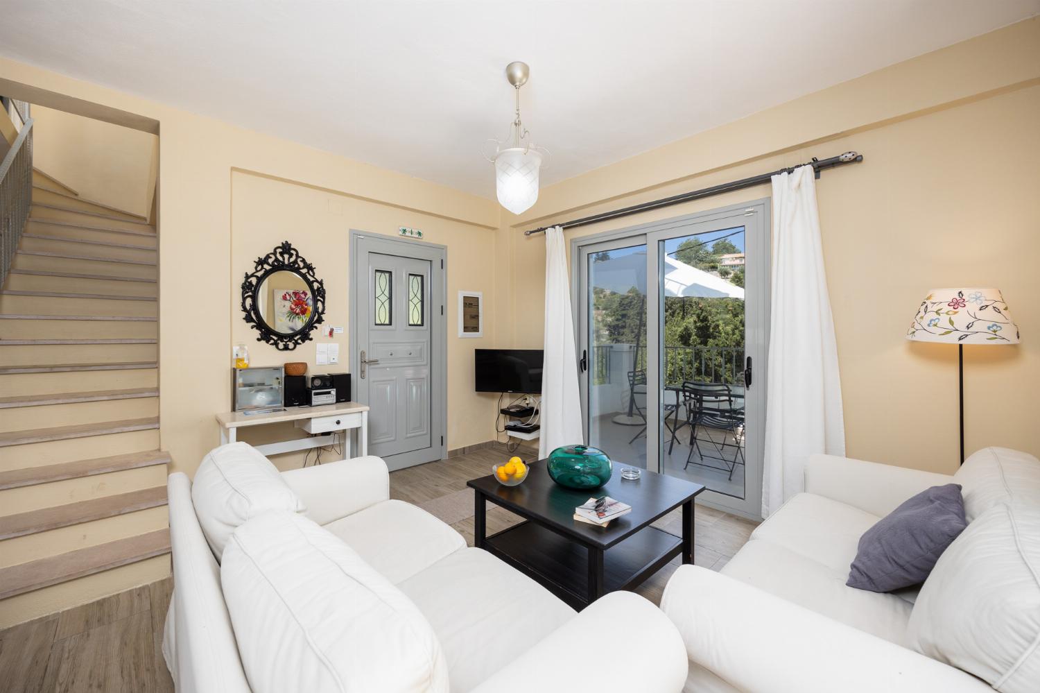 Open-plan living room with sofas, dining area, kitchen, WiFi internet, and satellite TV