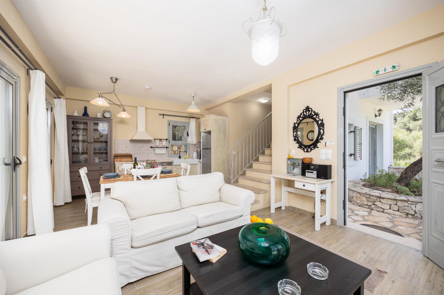 Open-plan living room with sofas, dining area, kitchen, WiFi internet, and satellite TV