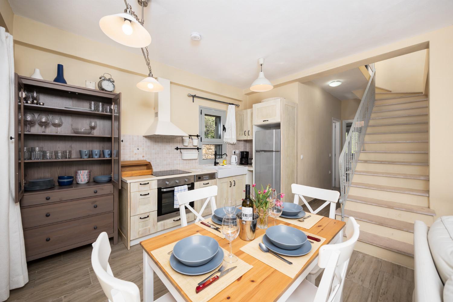 Open-plan living room with sofas, dining area, kitchen, WiFi internet, and satellite TV
