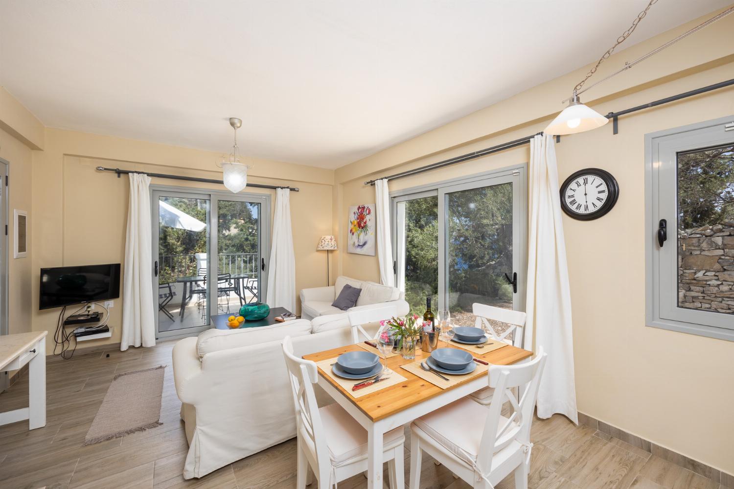 Open-plan living room with sofas, dining area, kitchen, WiFi internet, and satellite TV