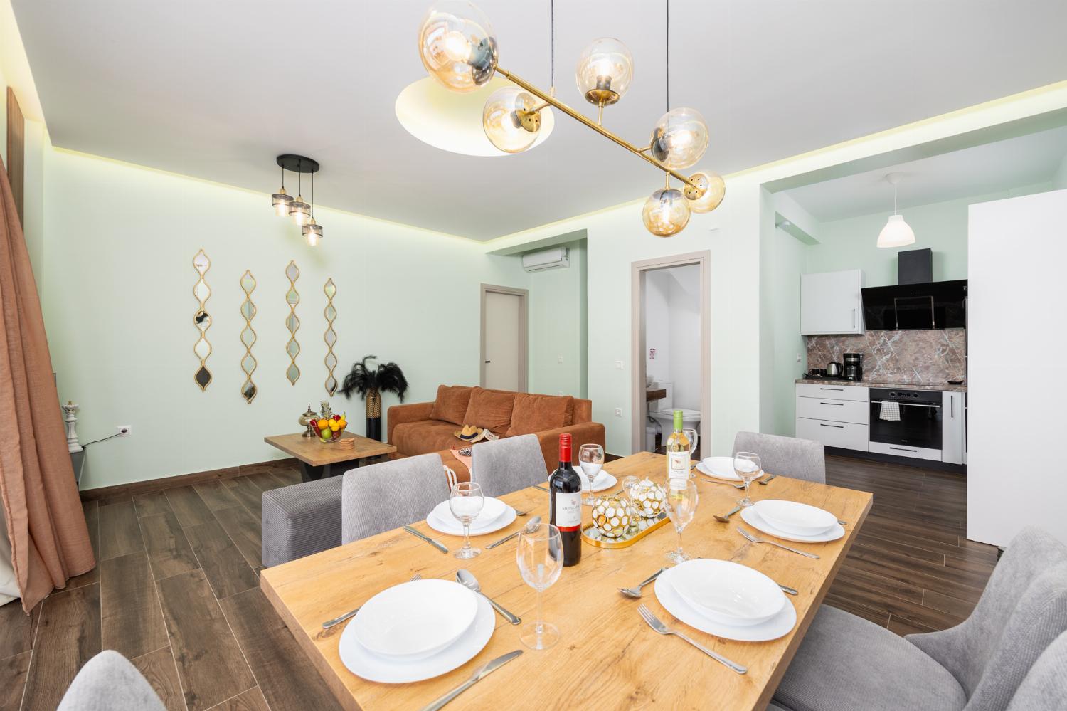 Open-plan living room with sofa, dining area, kitchen, A/C, WiFi internet, satellite TV, and sea views