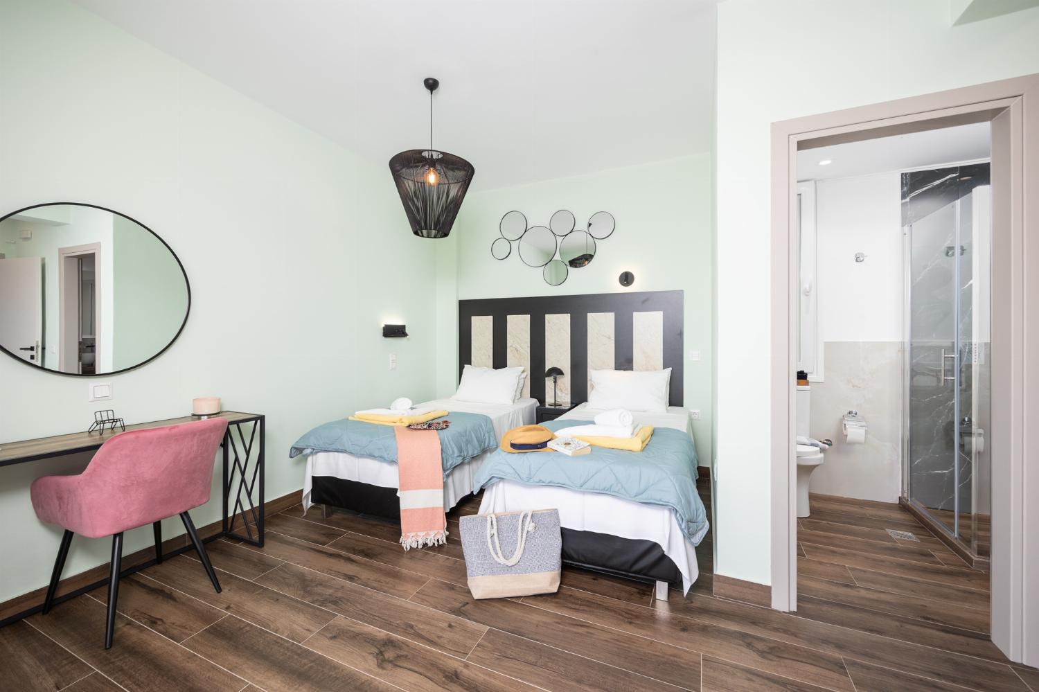 Twin bedroom with en suite bathroom, A/C, and sea views