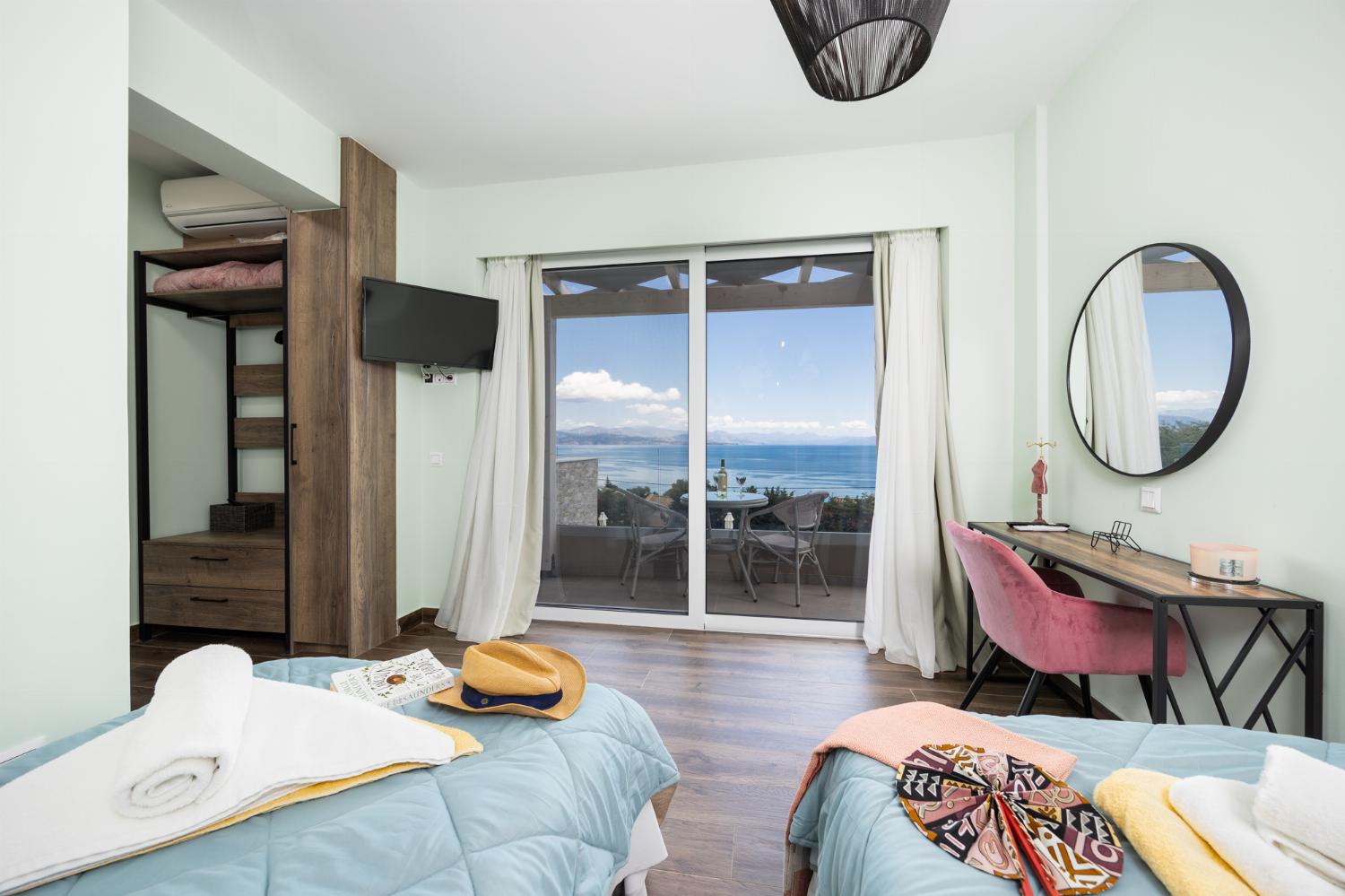 Twin bedroom with en suite bathroom, A/C, and sea views