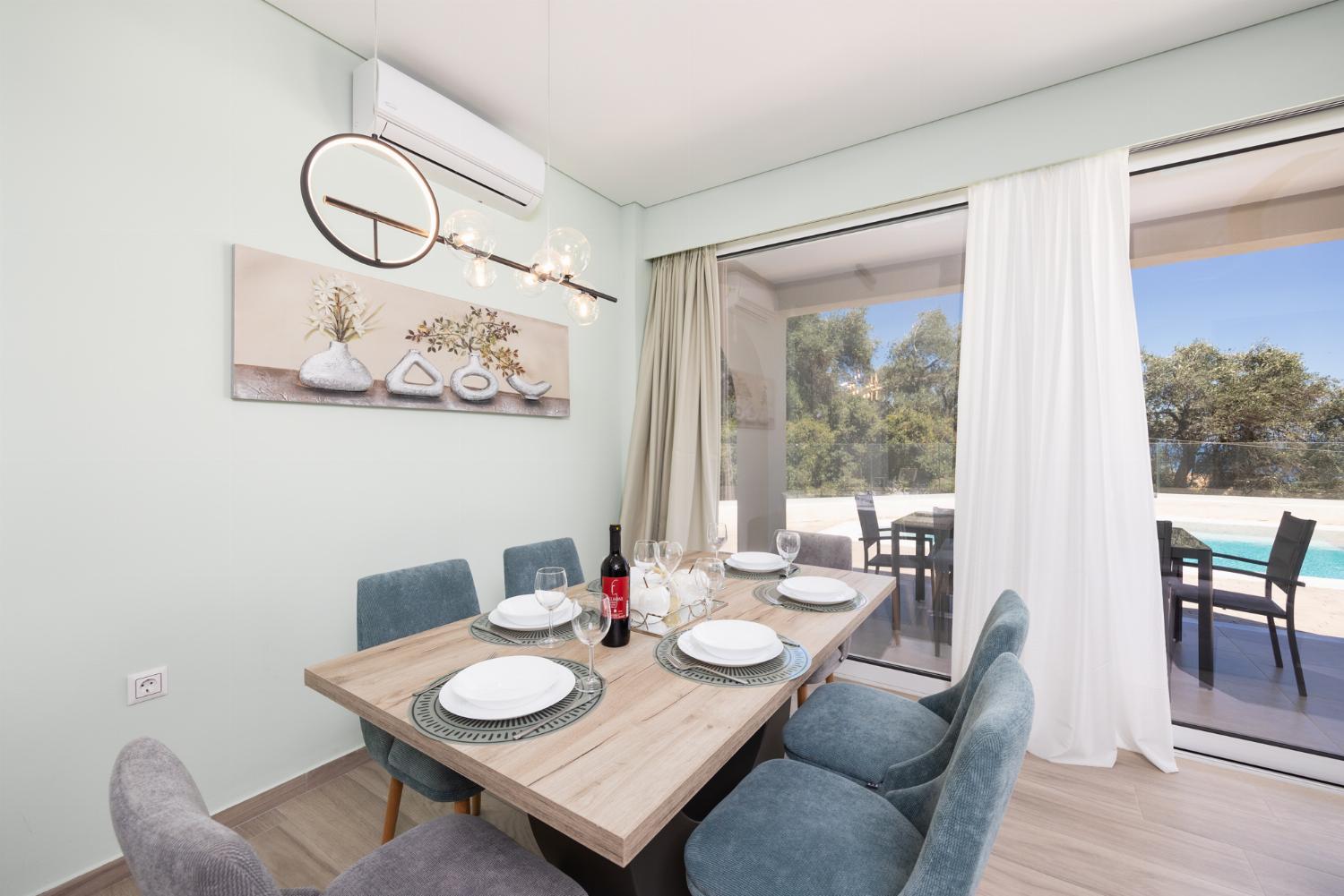Open-plan living room with sofa, dining area, kitchen, A/C, WiFi internet, and satellite TV