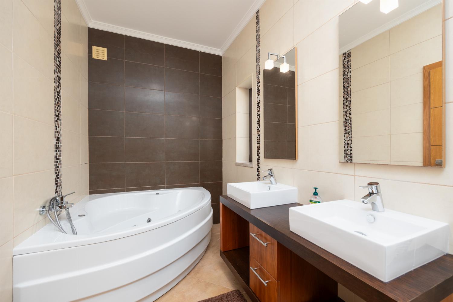 En suite bathroom with shower and jacuzzi