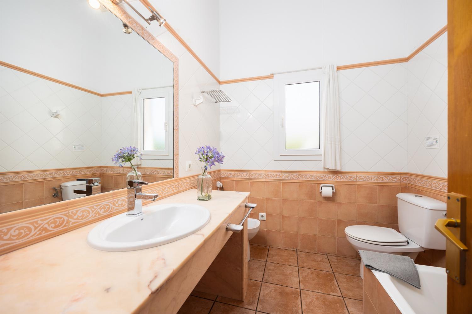 Family bathroom with bath and shower