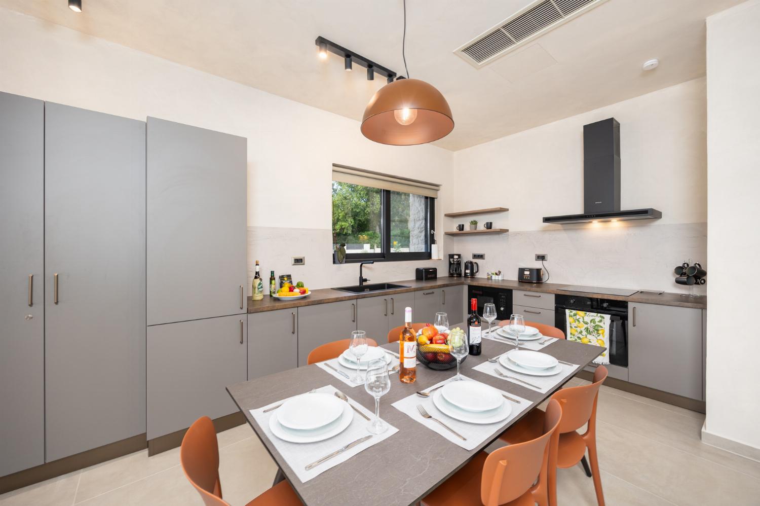 Open-plan living room with sofa, dining area, kitchen, A/C, WiFi internet, and satellite TV