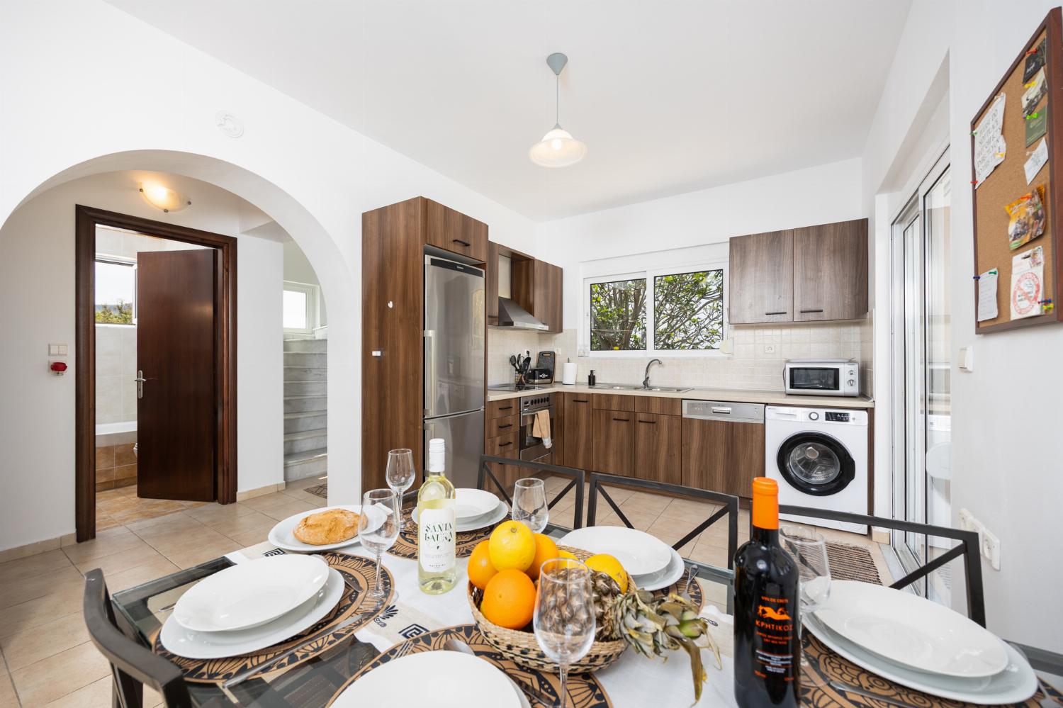 Open-plan living room with sofa, dining area, kitchen, A/C, WiFi internet, and satellite TV