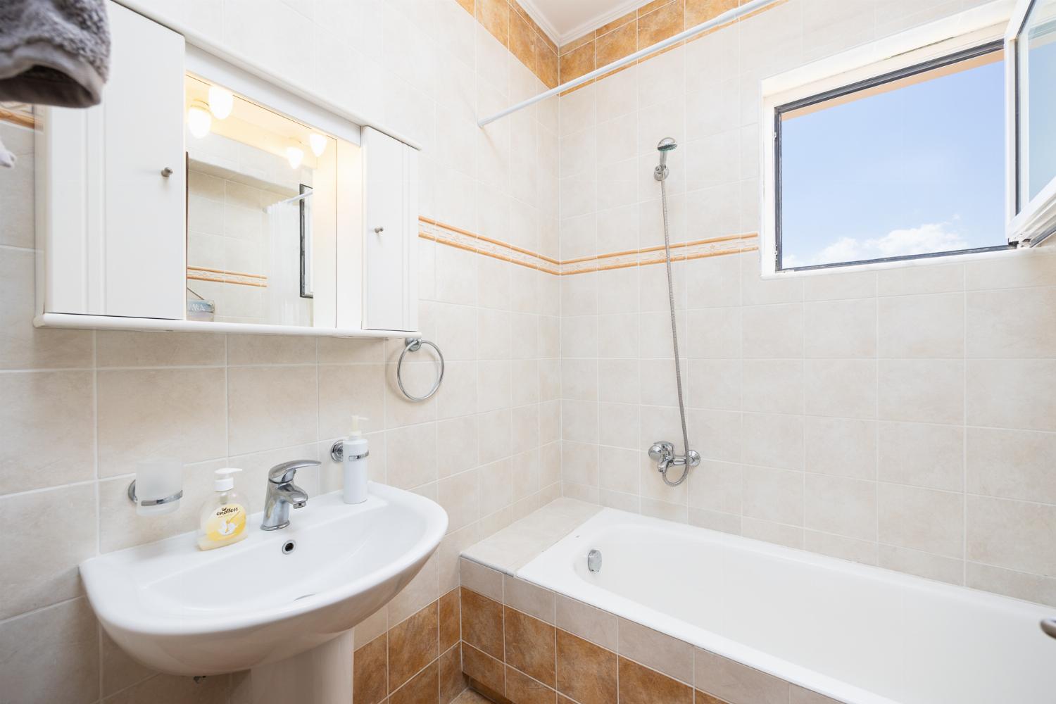 Family bathroom with bath and shower