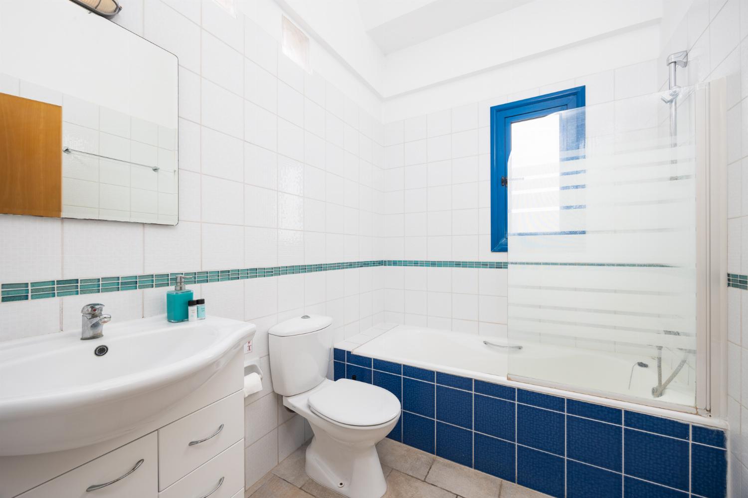 En suite bathroom with bath and shower