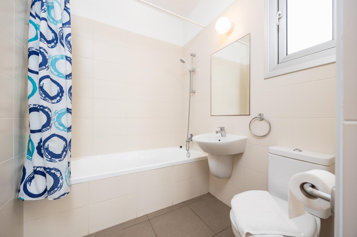 En suite bathroom with bath and shower