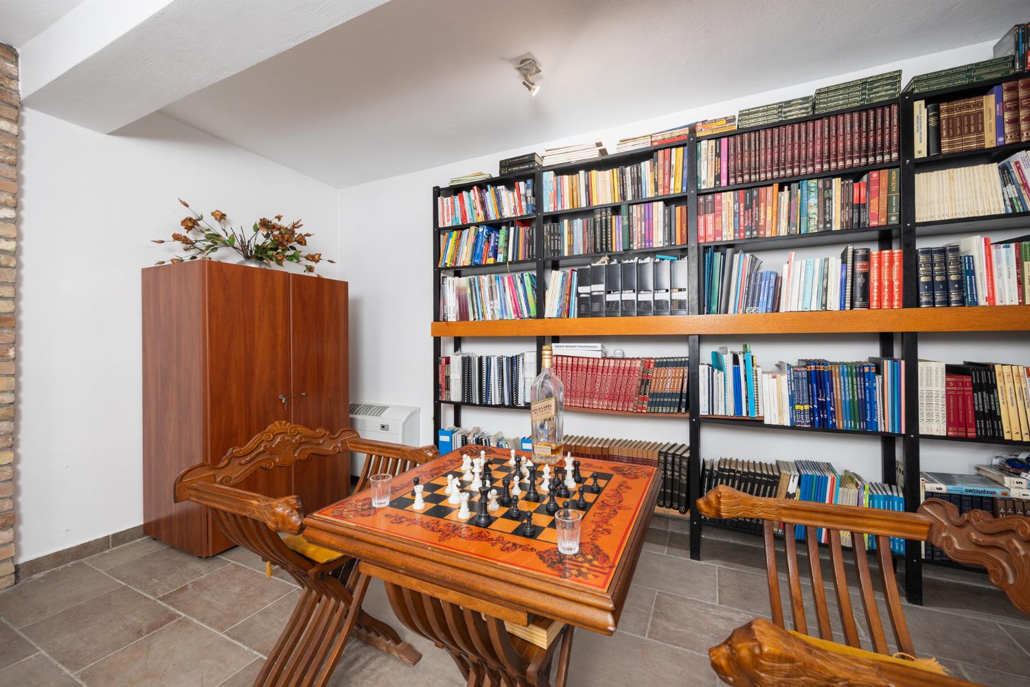 Open-plan living room on ground floor with sofas, dining area, bar area, ornamental fireplace, gym area, WiFi internet, and satellite TV