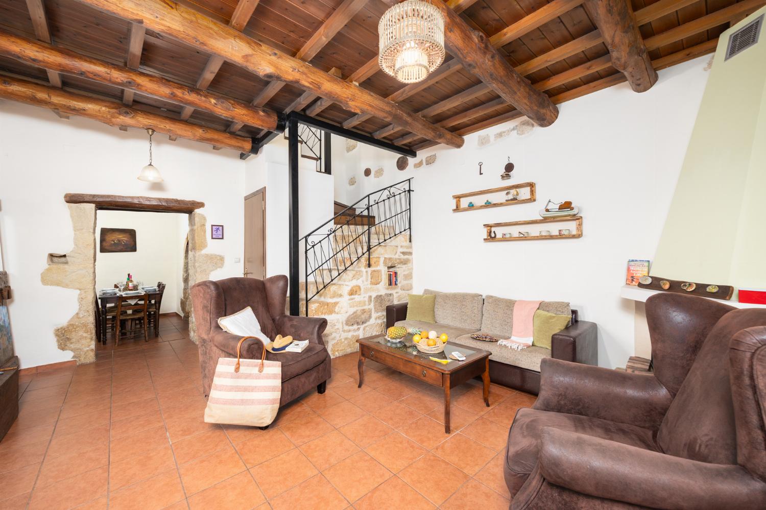 Living room with sofa, ornamental fireplace, A/C, WiFi internet, and satellite TV