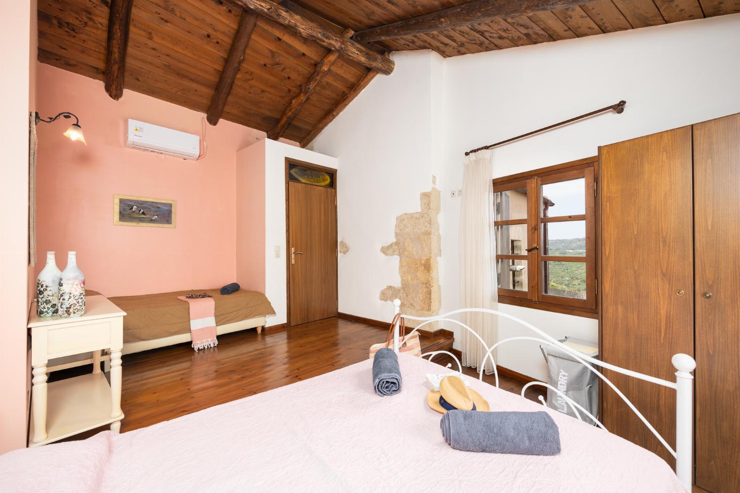 Bedroom with double bed, single bed, and A/C