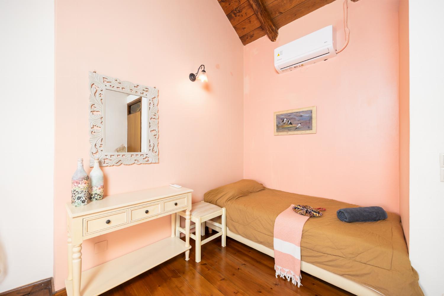 Bedroom with double bed, single bed, and A/C