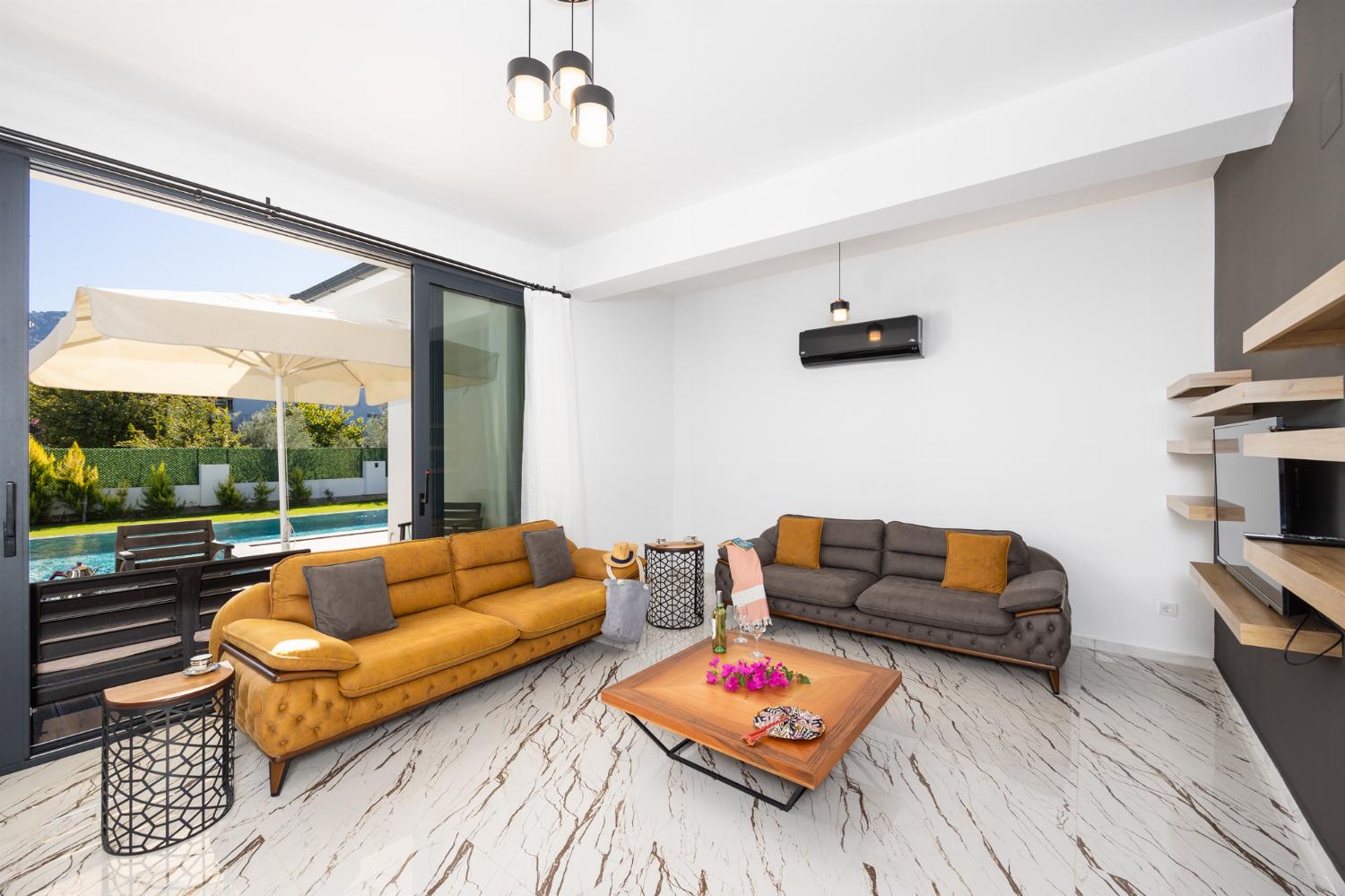 Living room with sofas, A/C, WiFi internet, and satellite TV