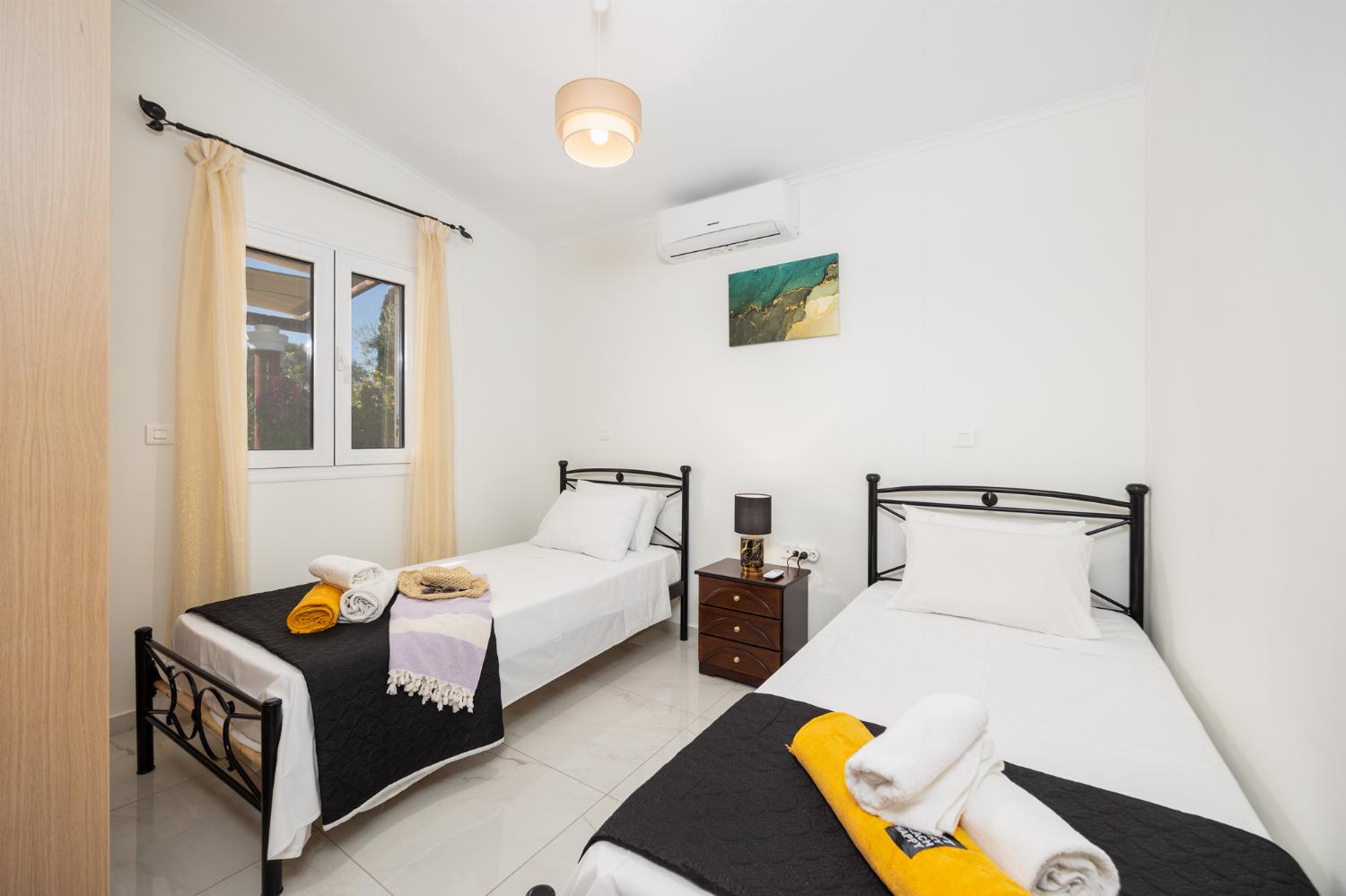 Open-plan living room with sofa, dining area, kitchen, A/C, WiFi internet, and satellite TV