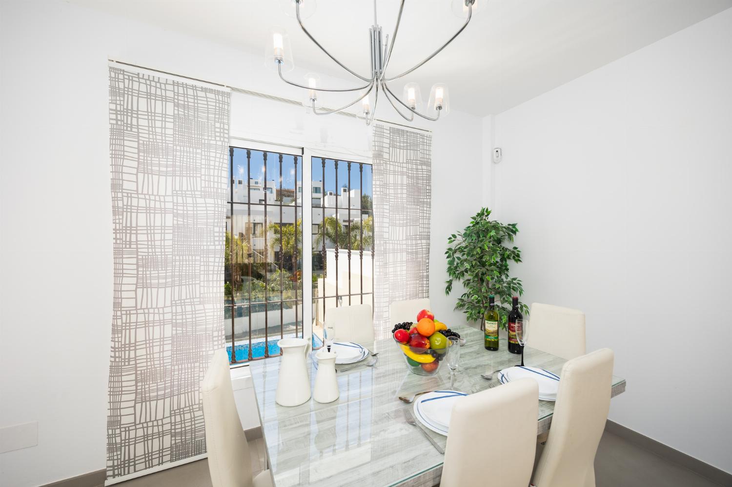 Living room with sofa, dining area, A/C, WiFi internet, and satellite TV