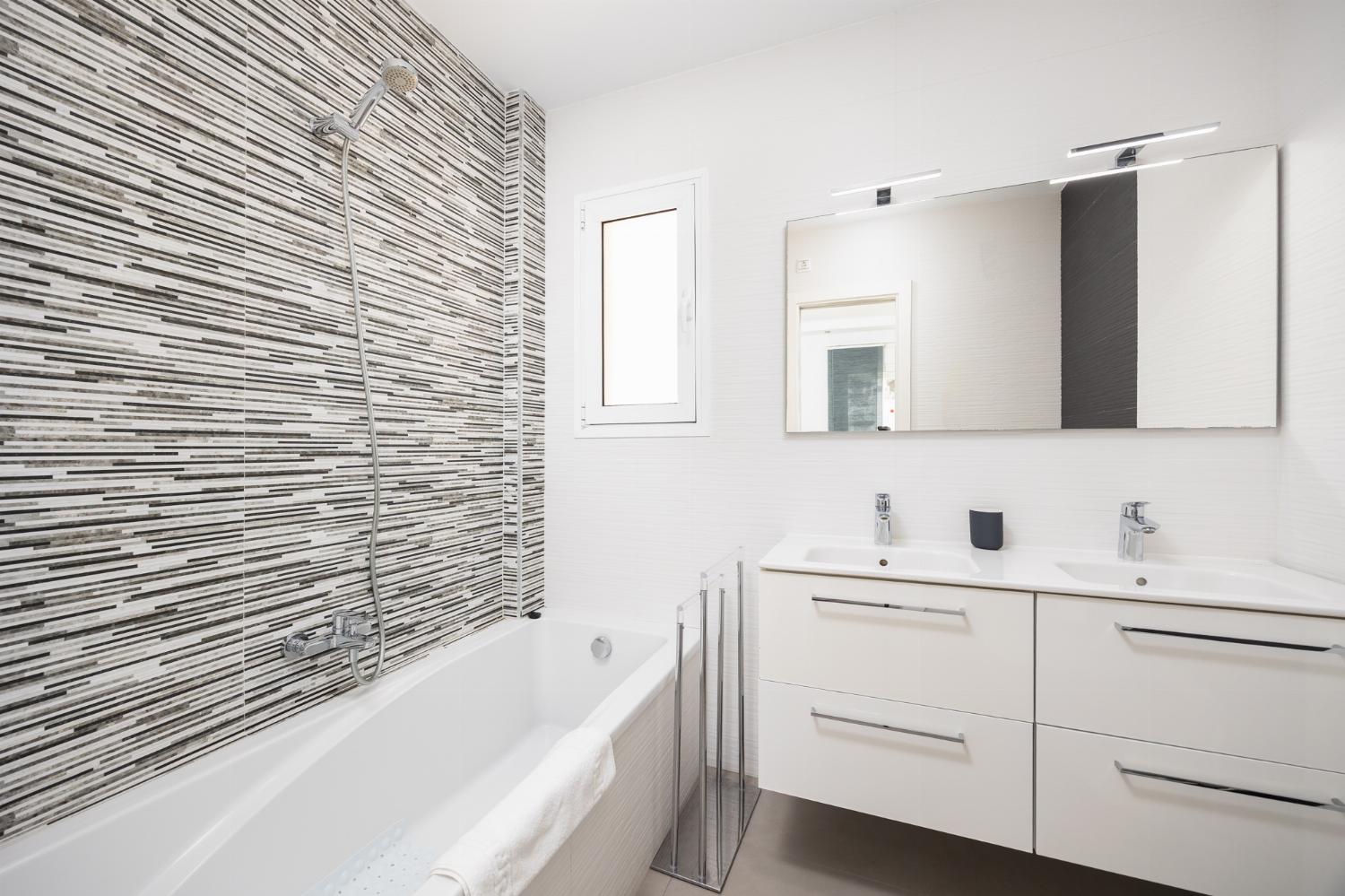 En suite bathroom with bath and shower