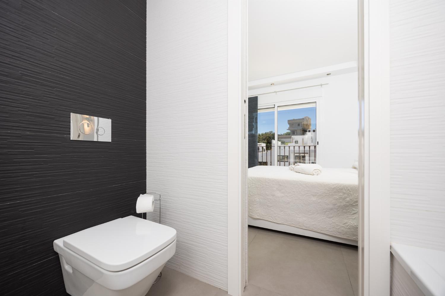 En suite bathroom with bath and shower