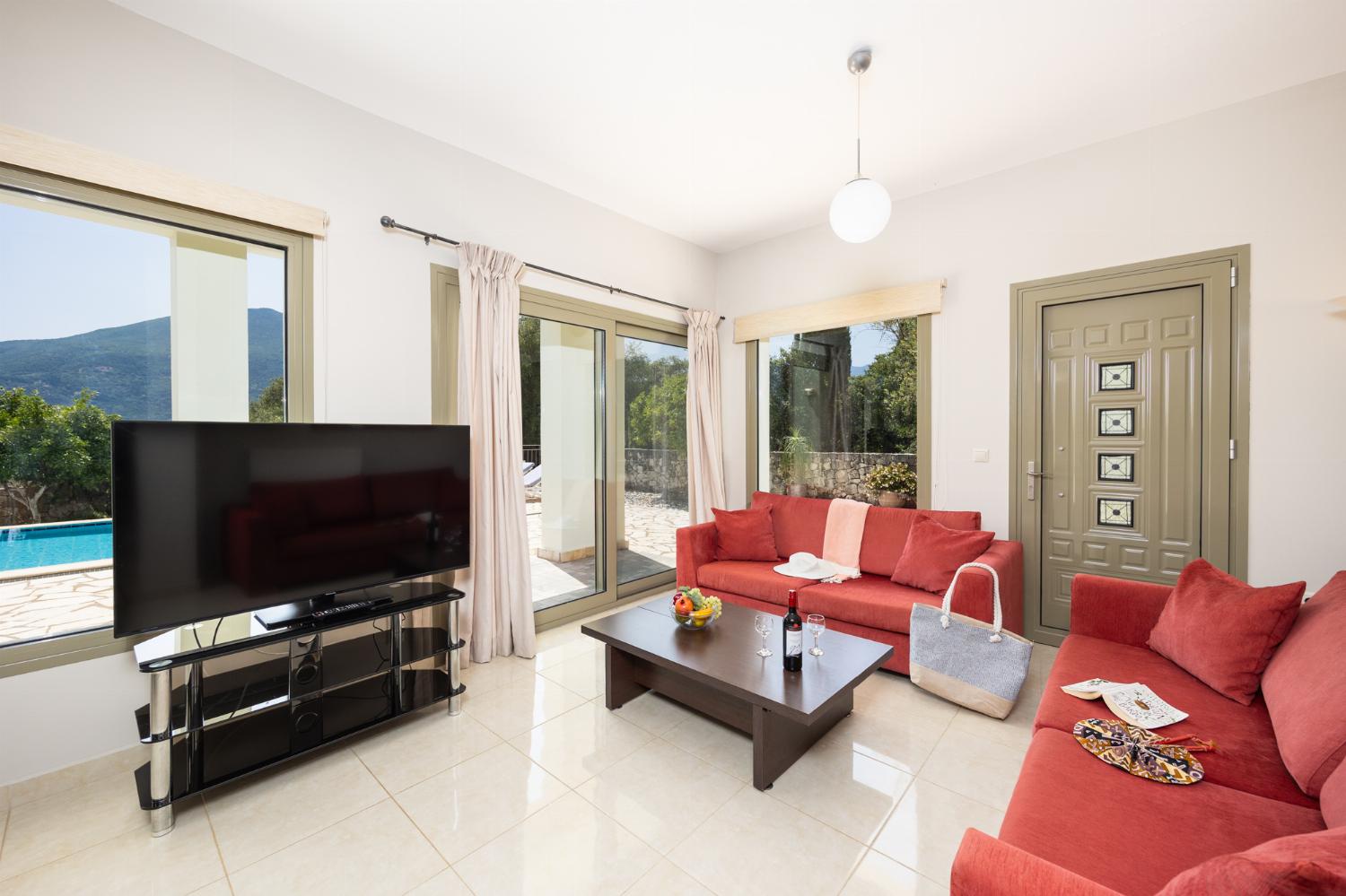 Open-plan living room with sofas, dining area, kitchen, WiFi internet, and satellite TV