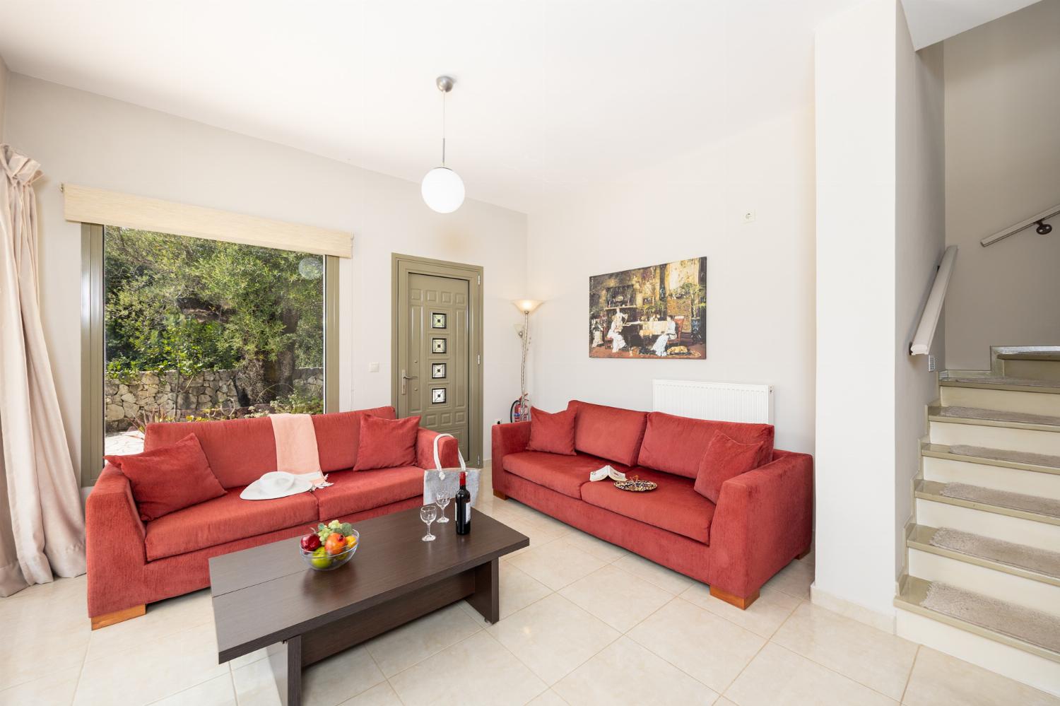 Open-plan living room with sofas, dining area, kitchen, WiFi internet, and satellite TV