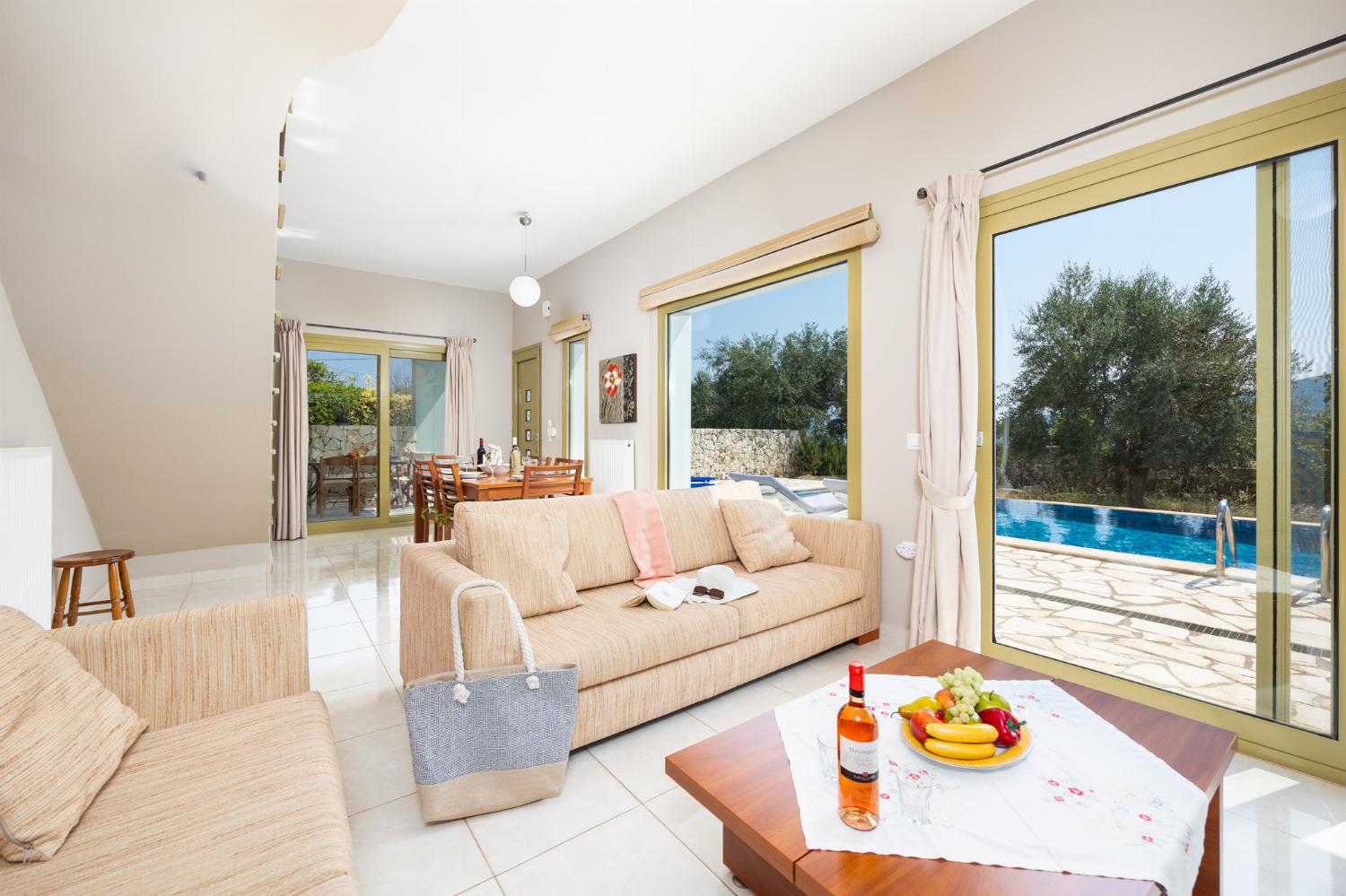 Living room with sofas, dining area, ornamental fireplace, A/C, WiFi internet, and satellite TV