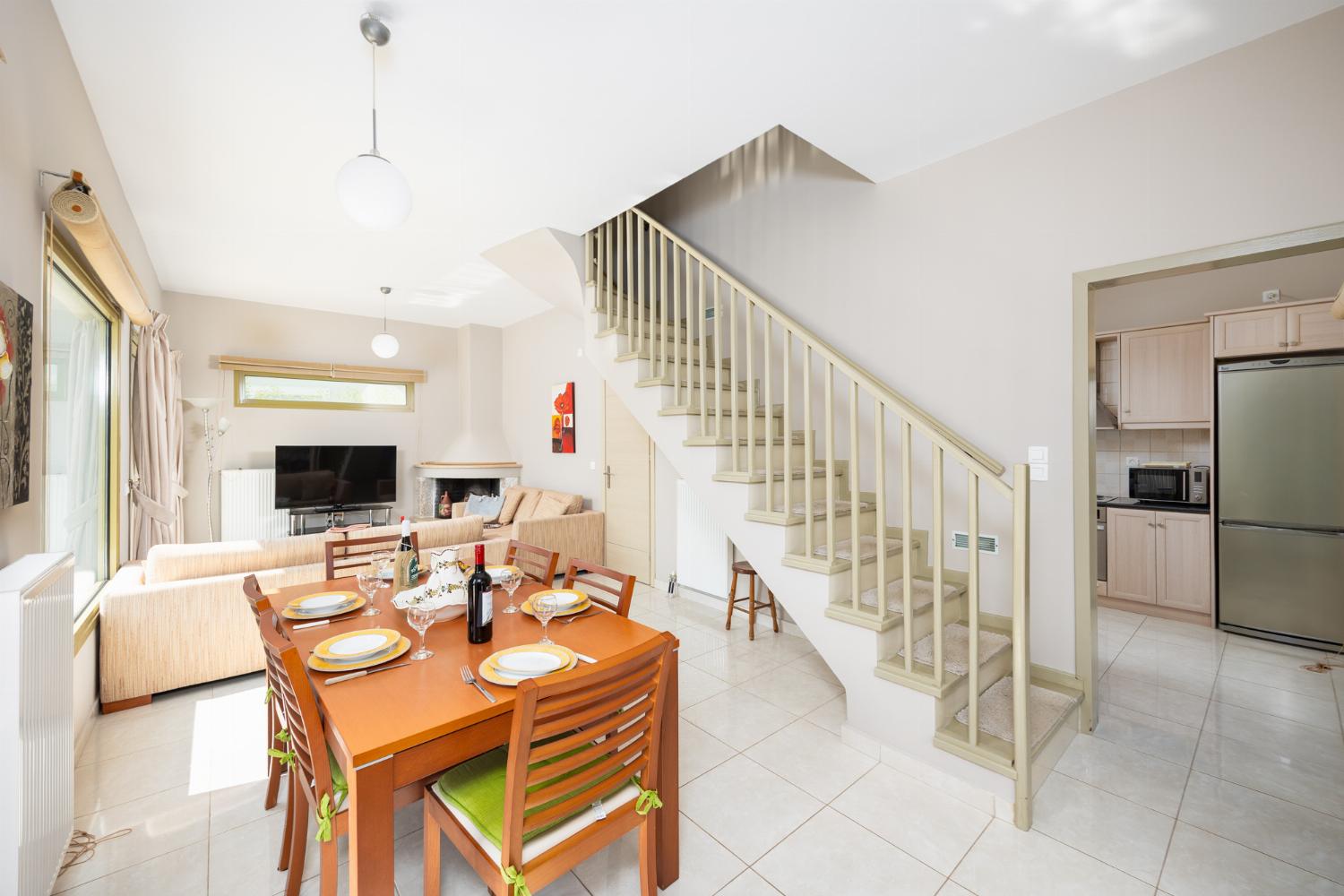 Living room with sofas, dining area, ornamental fireplace, A/C, WiFi internet, and satellite TV
