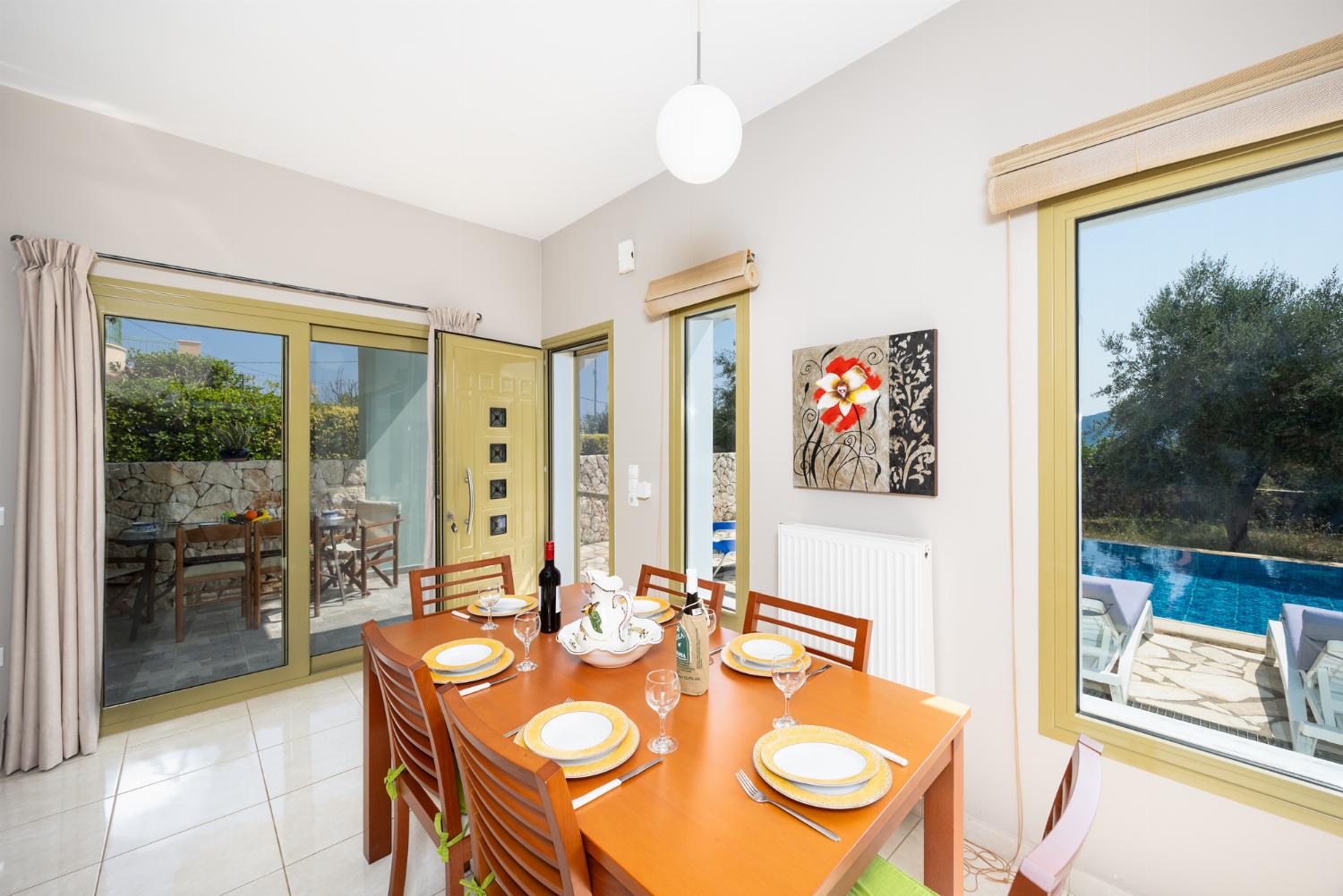 Living room with sofas, dining area, ornamental fireplace, A/C, WiFi internet, and satellite TV