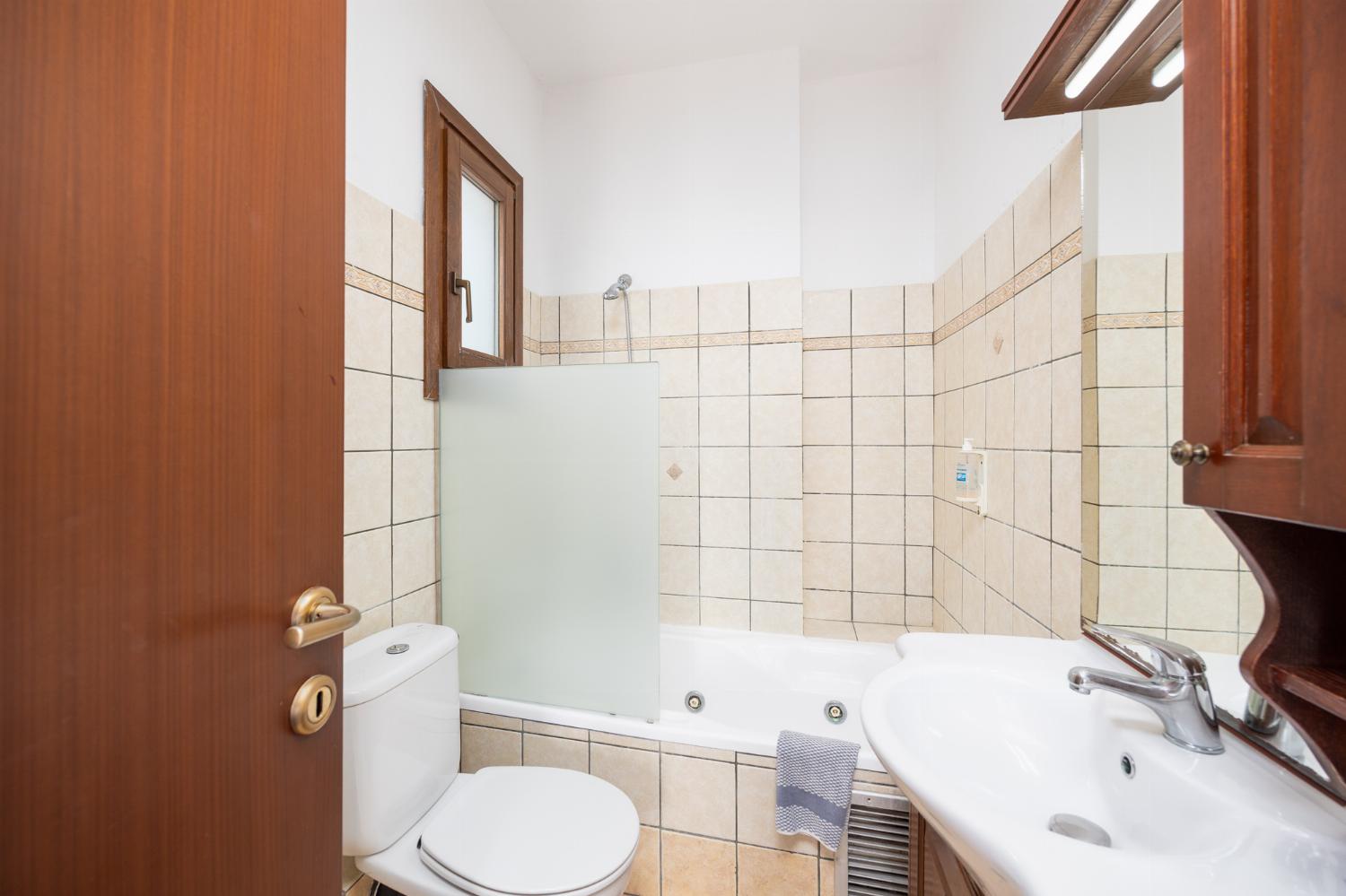 En suite bathroom with bath and shower