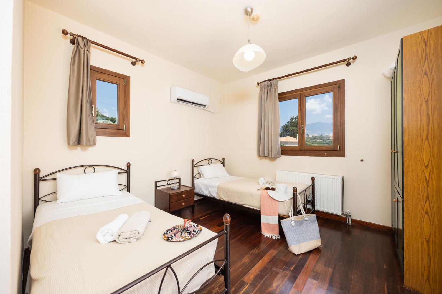Twin bedroom with en suite bathroom and A/C