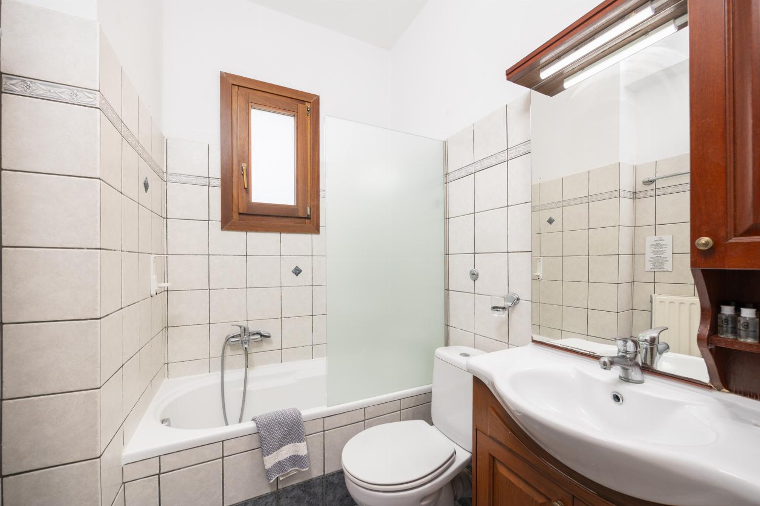 En suite bathroom with bath and shower
