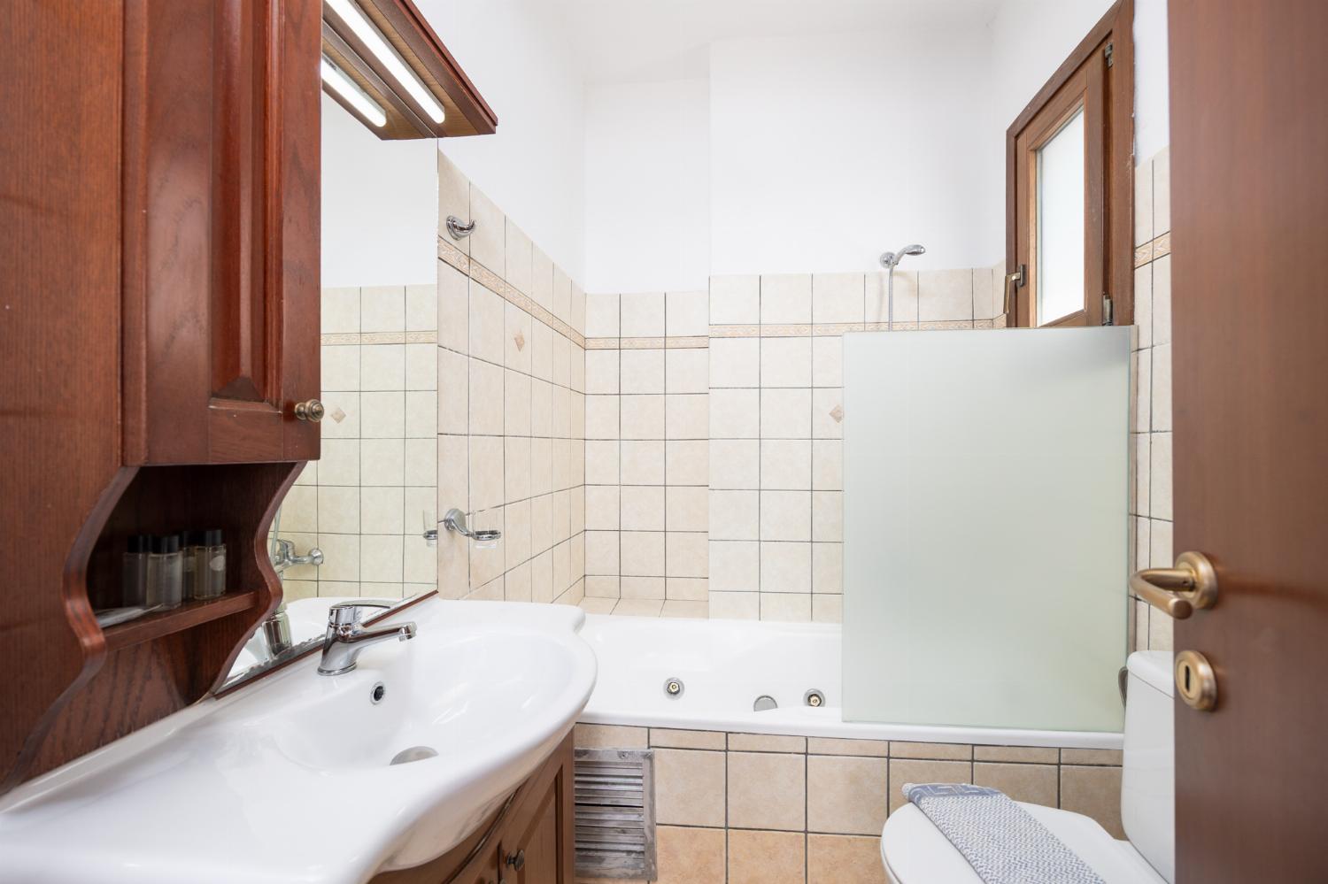 En suite bathroom with bath and shower