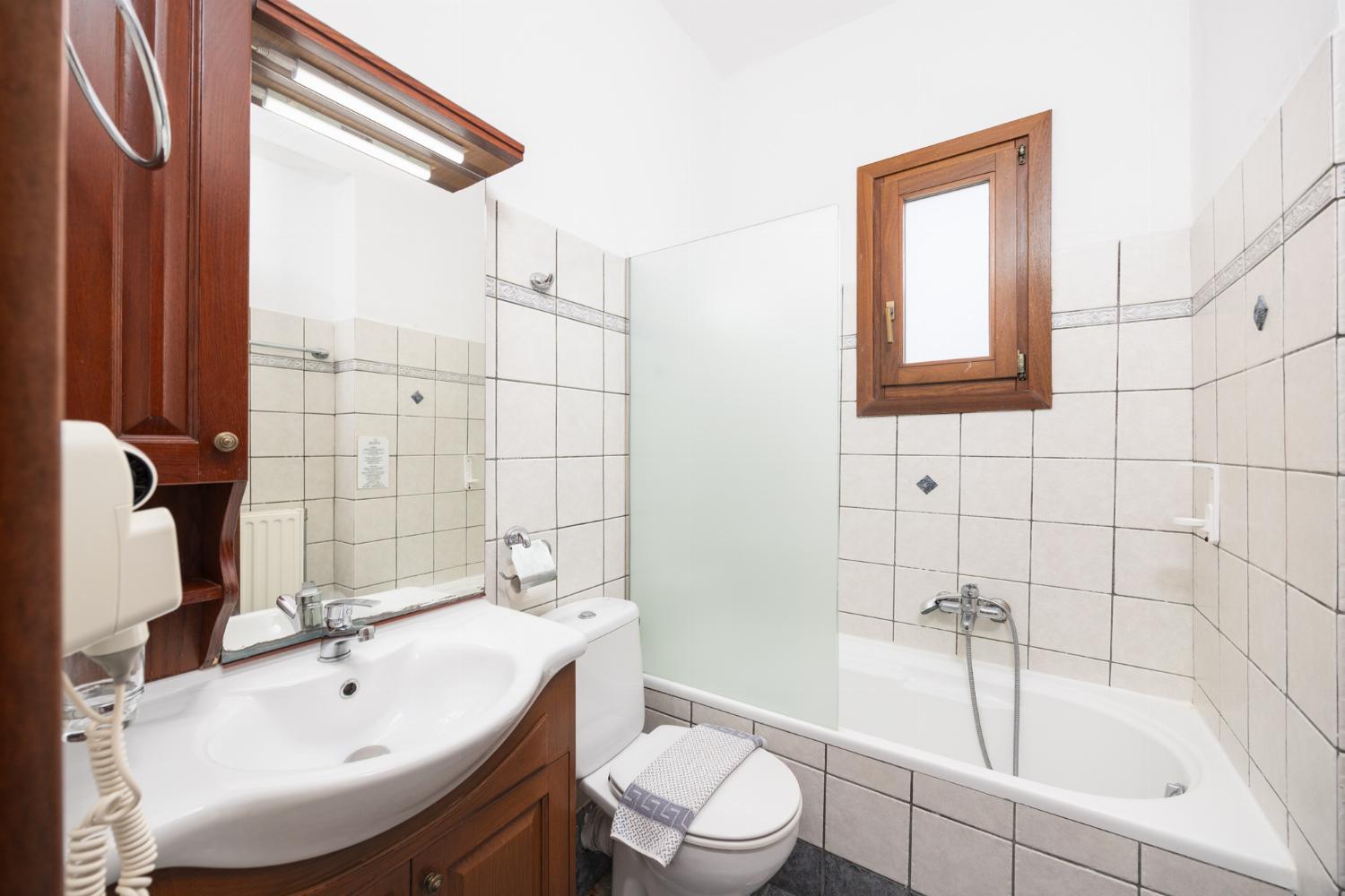 En suite bathroom with bath and shower