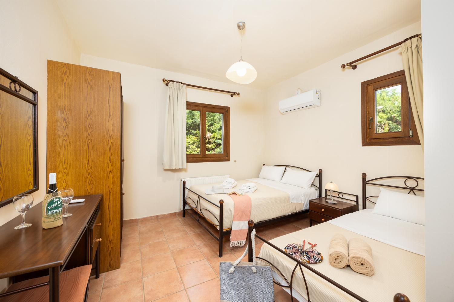 Bedroom with double bed and single bed, and A/C