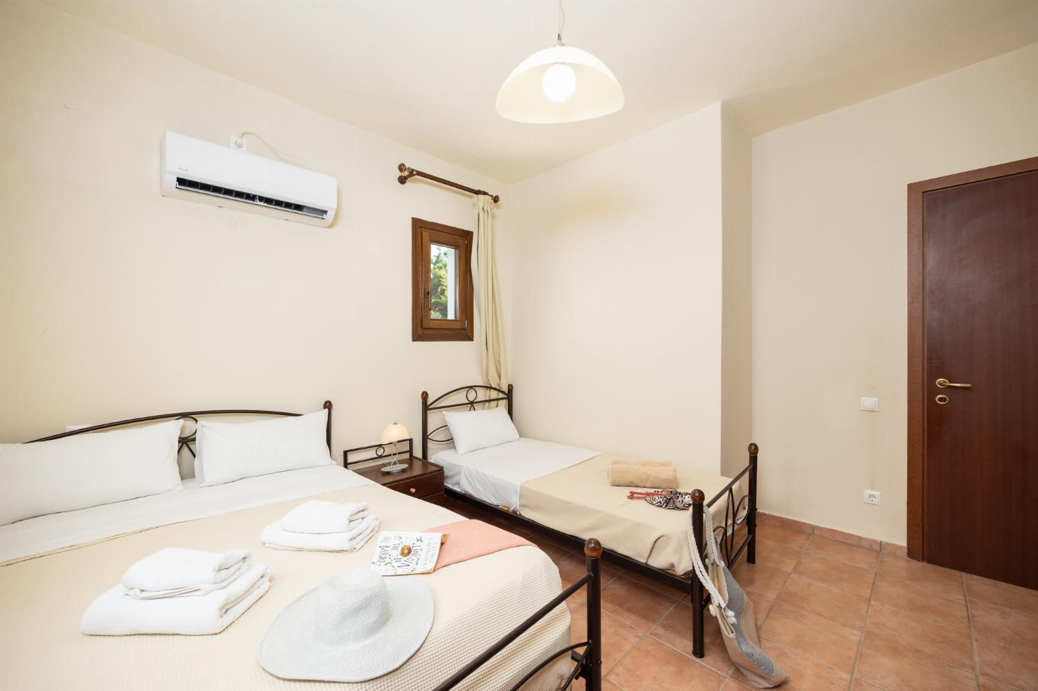 Bedroom with double bed and single bed, and A/C