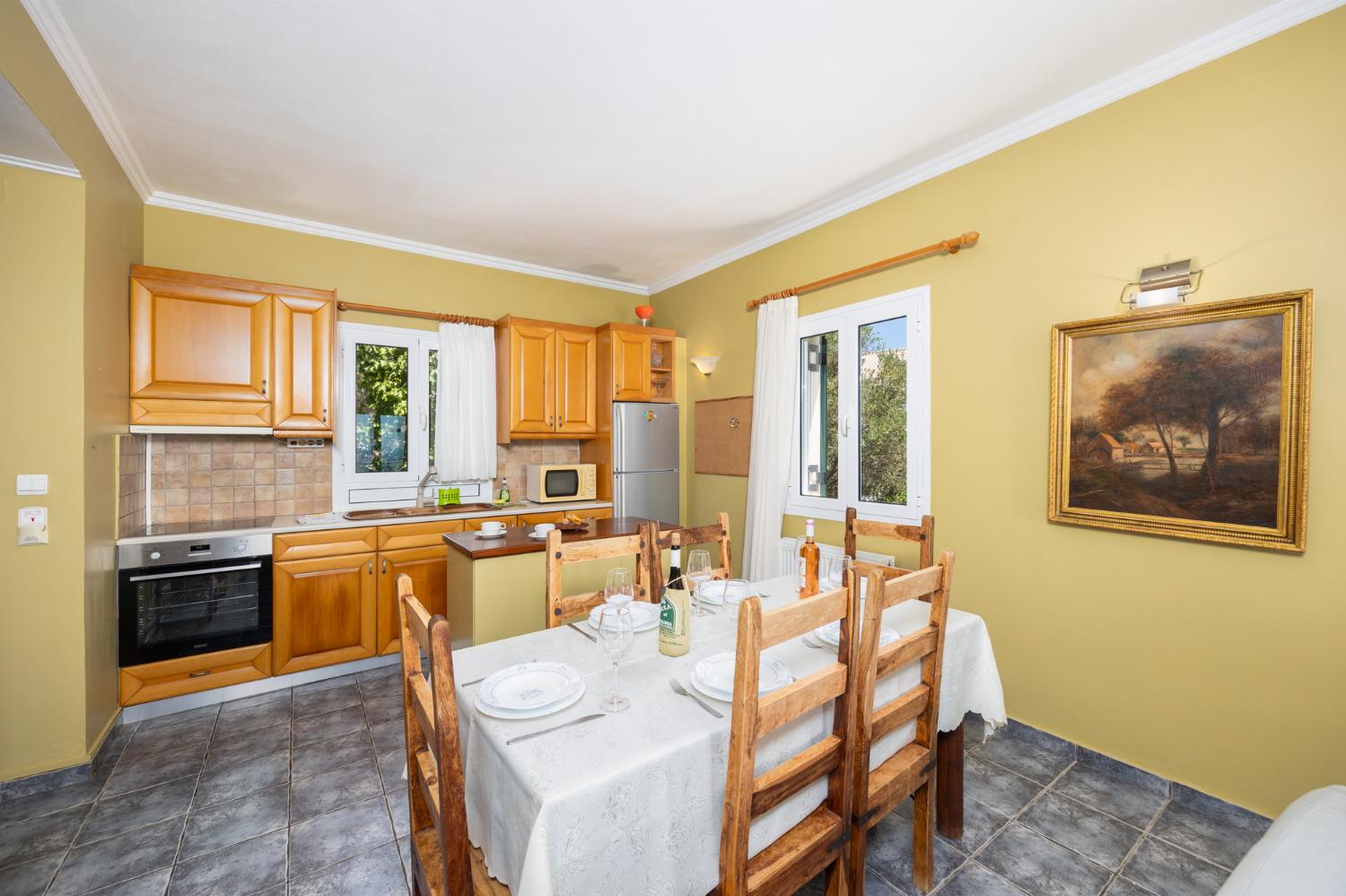 Open-plan living room with sofas, dining area, kitchen, ornamental fireplace, A/C, WiFi internet, satellite TV, and sea views