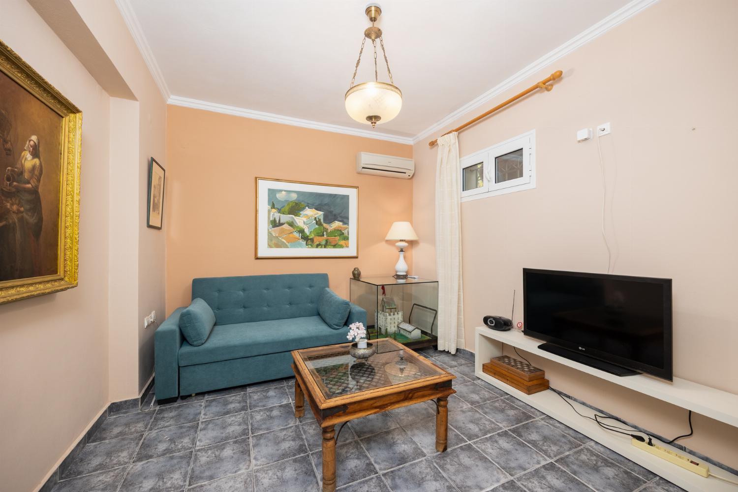 Downstairs apartment: living room with sofa, A/C, WiFi internet, and satellite TV