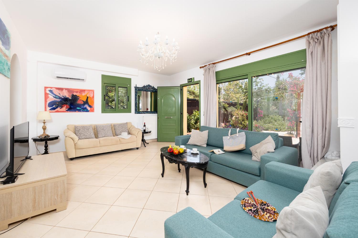 Living room with sofas, dining area, A/C, WiFi internet, and satellite TV